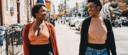 Two friends are walking in a street of Bushwick, Brooklyn