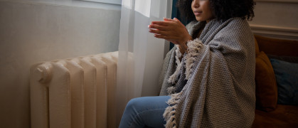 Woman feel cold in home with no heating stock photo