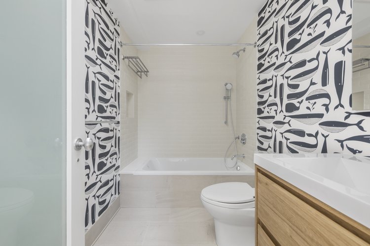Bolster's Tribeca townhouse renovation added a children's bath with a tub and fun wallpaper.