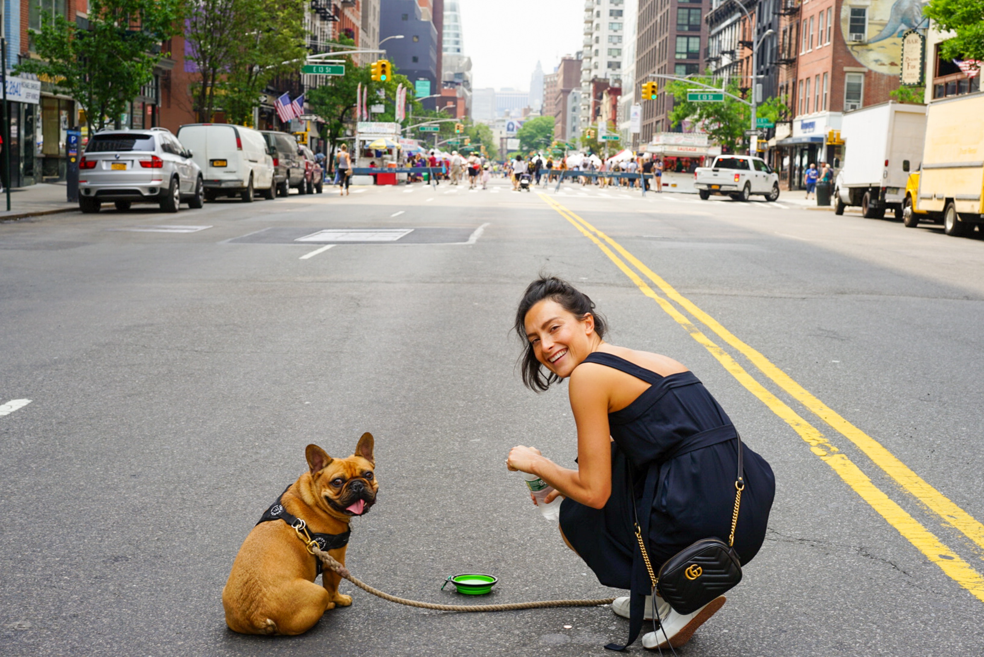 Photo of a woman with her dog on a street in New York City