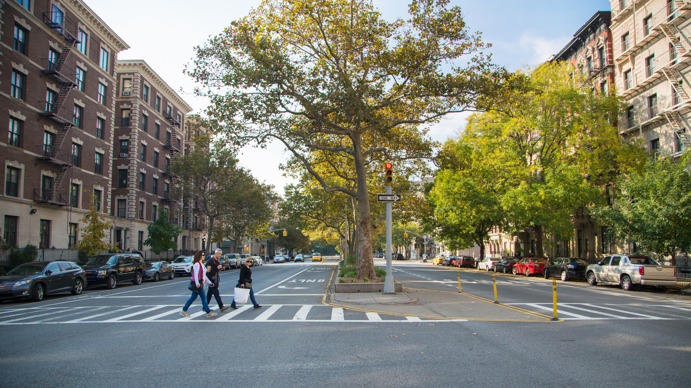 Shoppers walking in crosswalk Harlem, NYC
