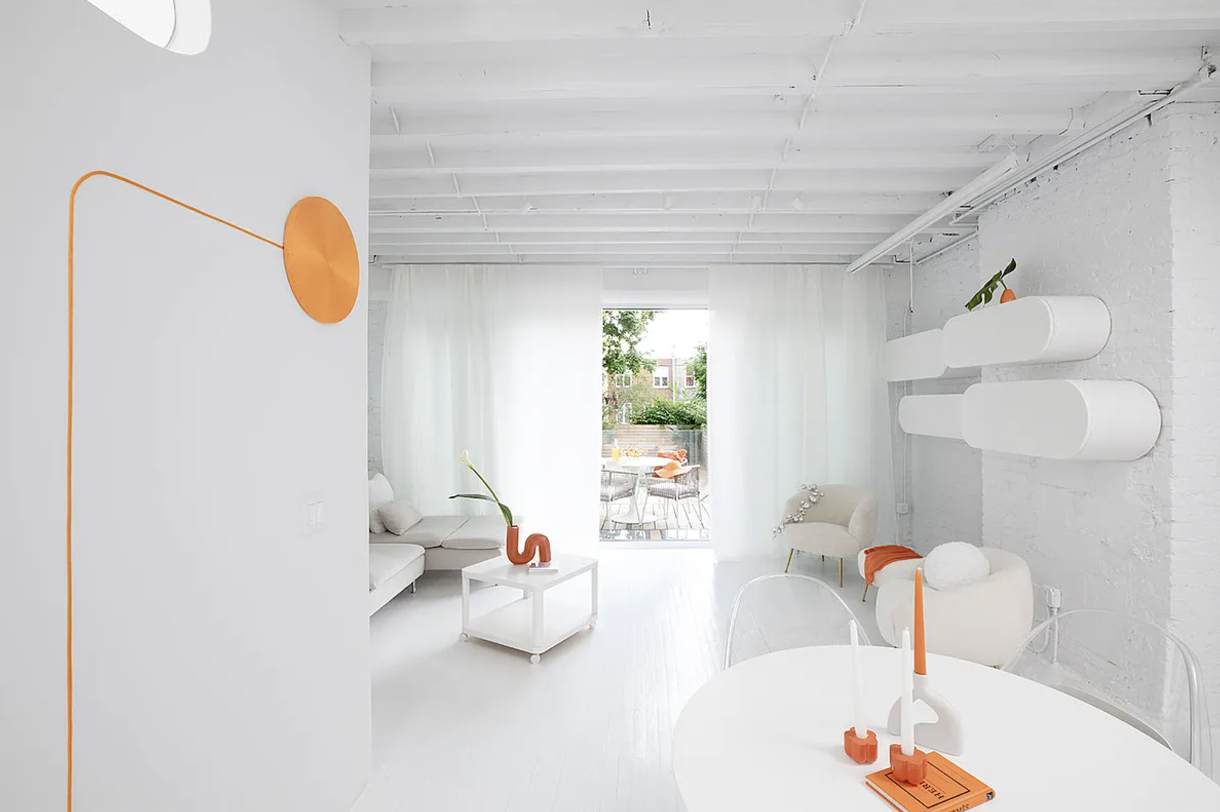 Orange accents decorate white walls inside 1432 Saint Mark's Avenue. Orange accents decorate white walls inside 1432 Saint Mark's Avenue.