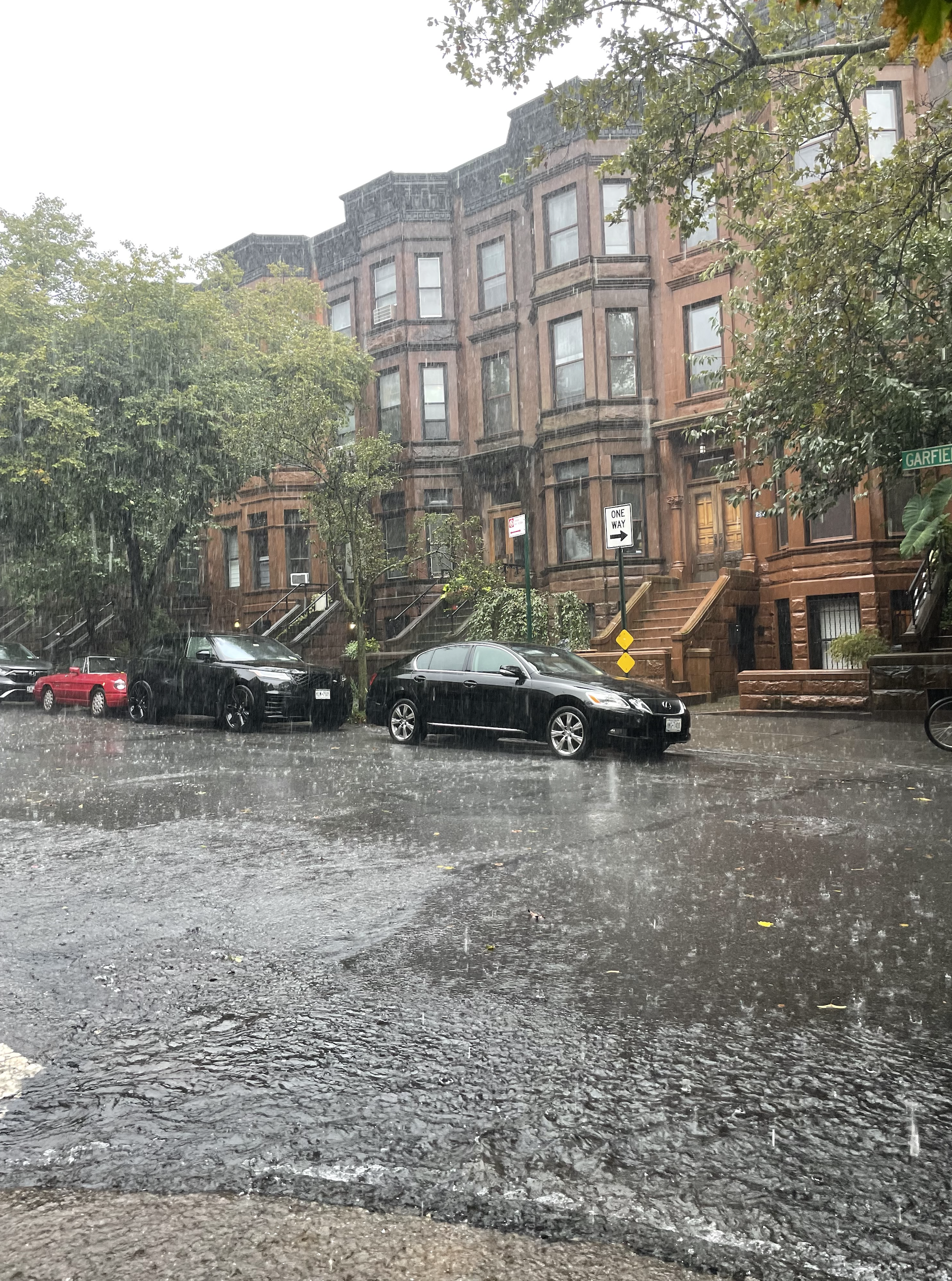 Flood water in residential Park Slope, Brooklyn flows downhill. Flood water in residential Park Slope, Brooklyn flows downhill.