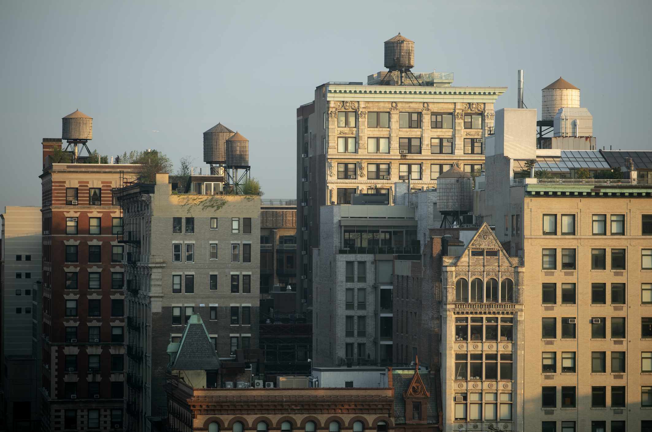 Residential buildings in NoHo neighborhood of New York City. Several tall residential buildings in NoHo, New York City, draped by sunlight.