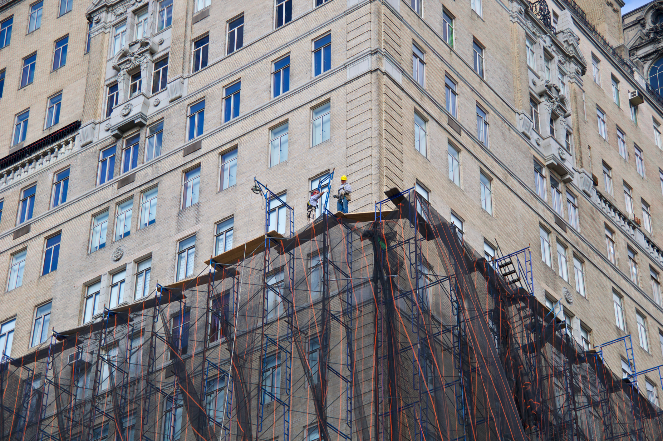 Scaffold workmen on high rise facade, New York City stock photo