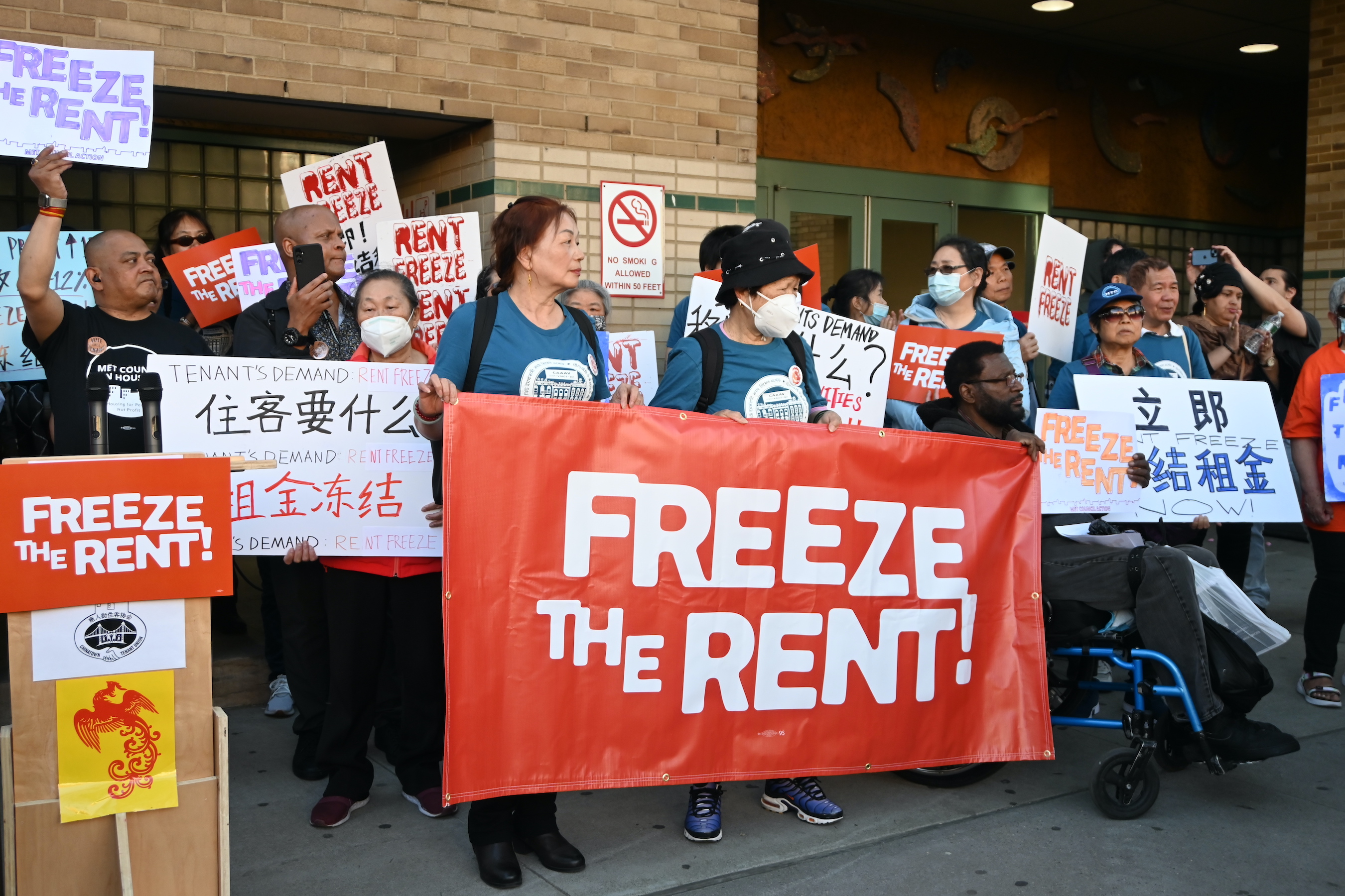 Organizers from CAAAV Organizing Asian Communities held signs calling for a rent freeze.