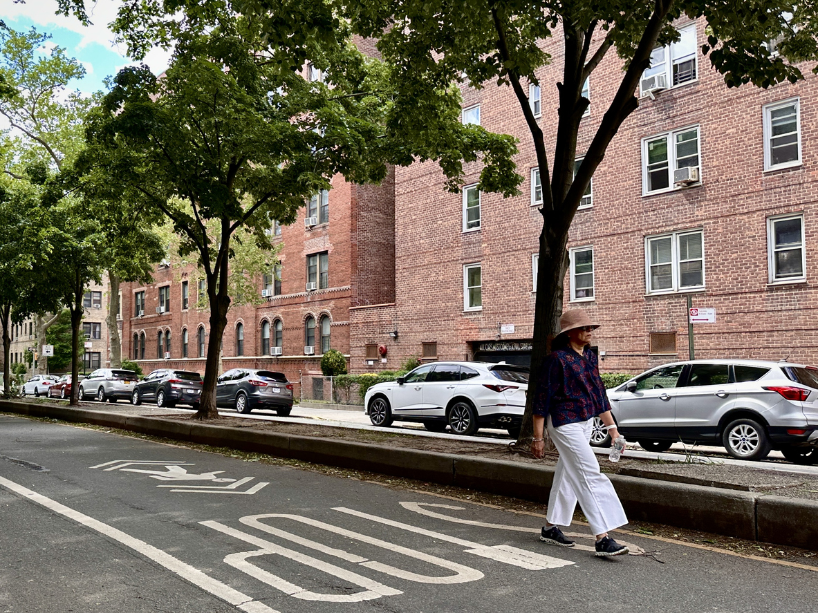 Woman walking down street in Jackson Heights
