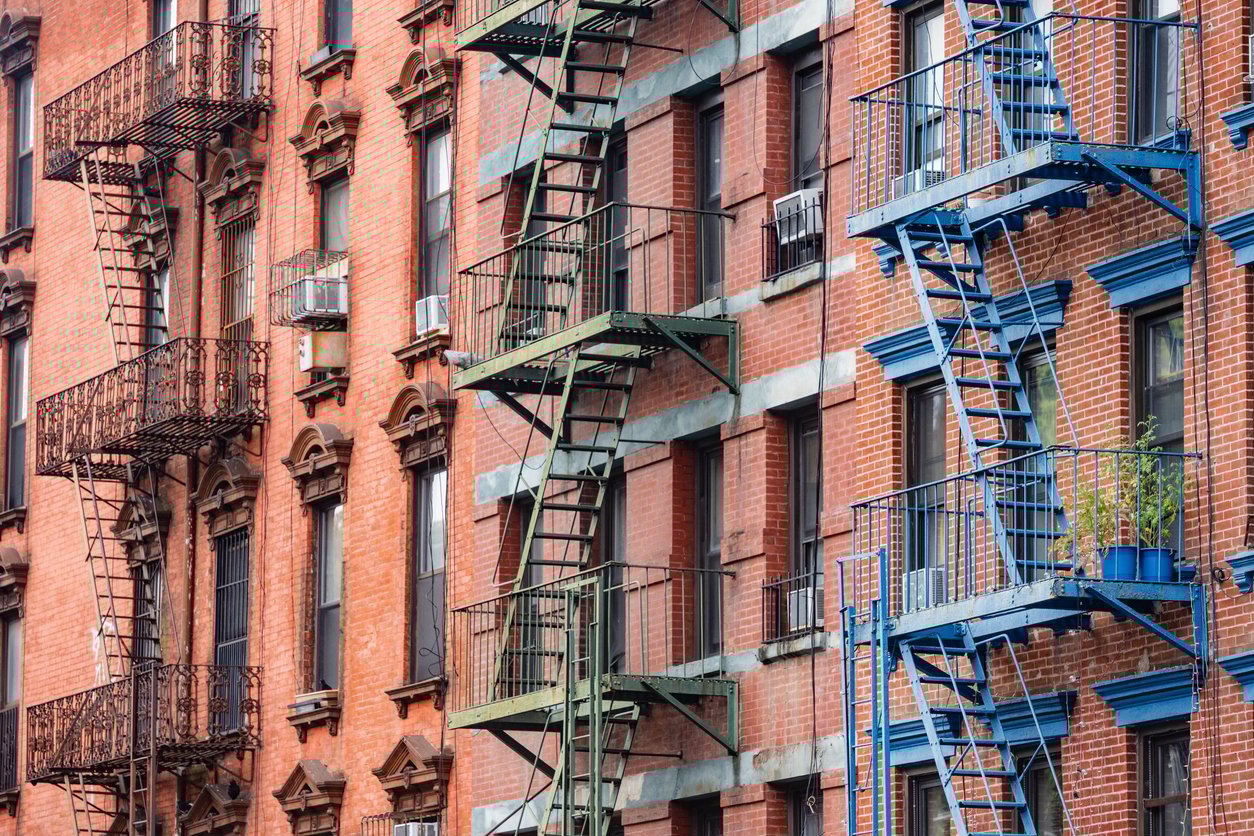 This is a photograph of brightly painted fire escapes on historic brick buildings in the Lower East Side of Manhattan. This is a photograph of brightly painted fire escapes on historic brick buildings in the Lower East Side of Manhattan.