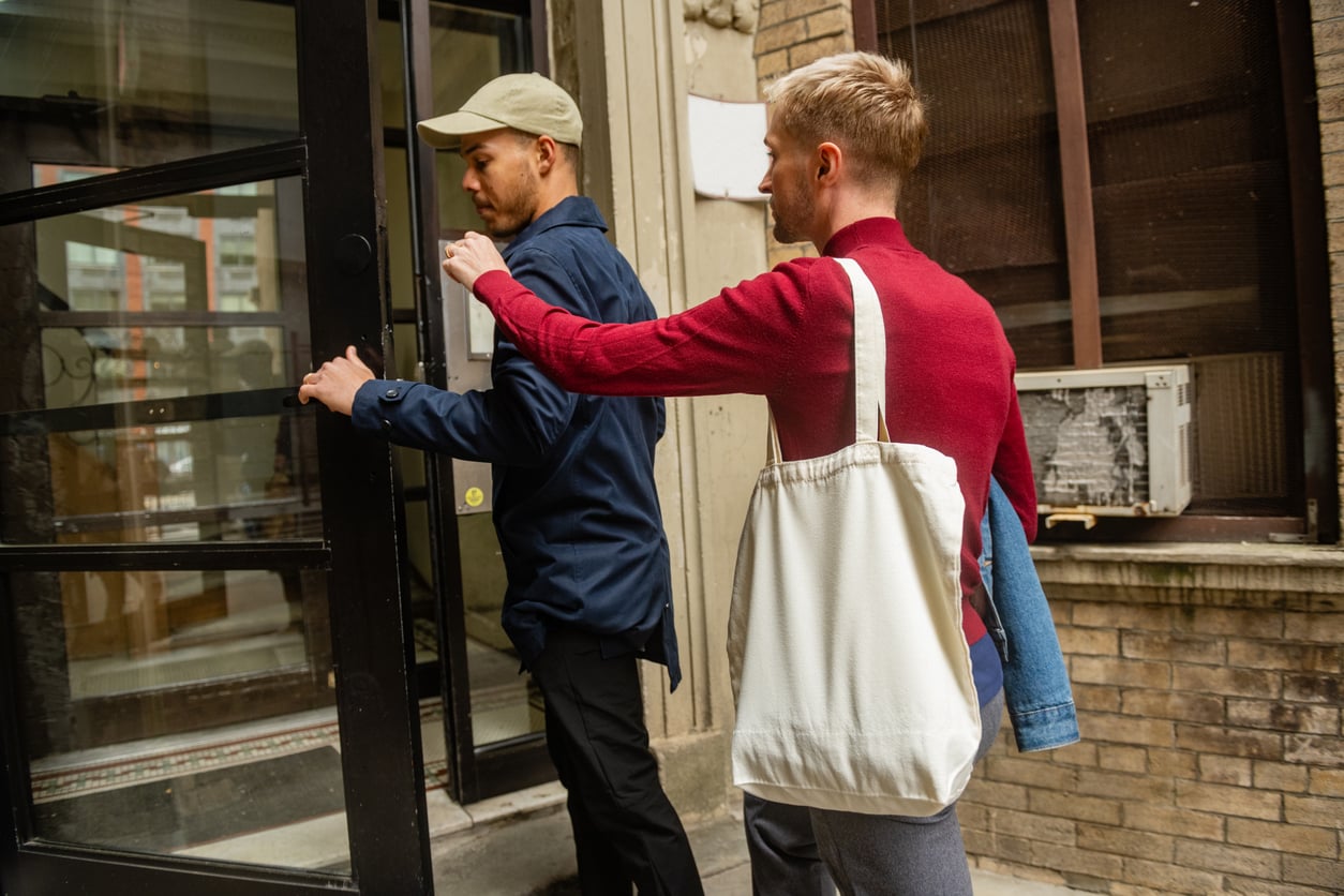 Two men entering a residential building