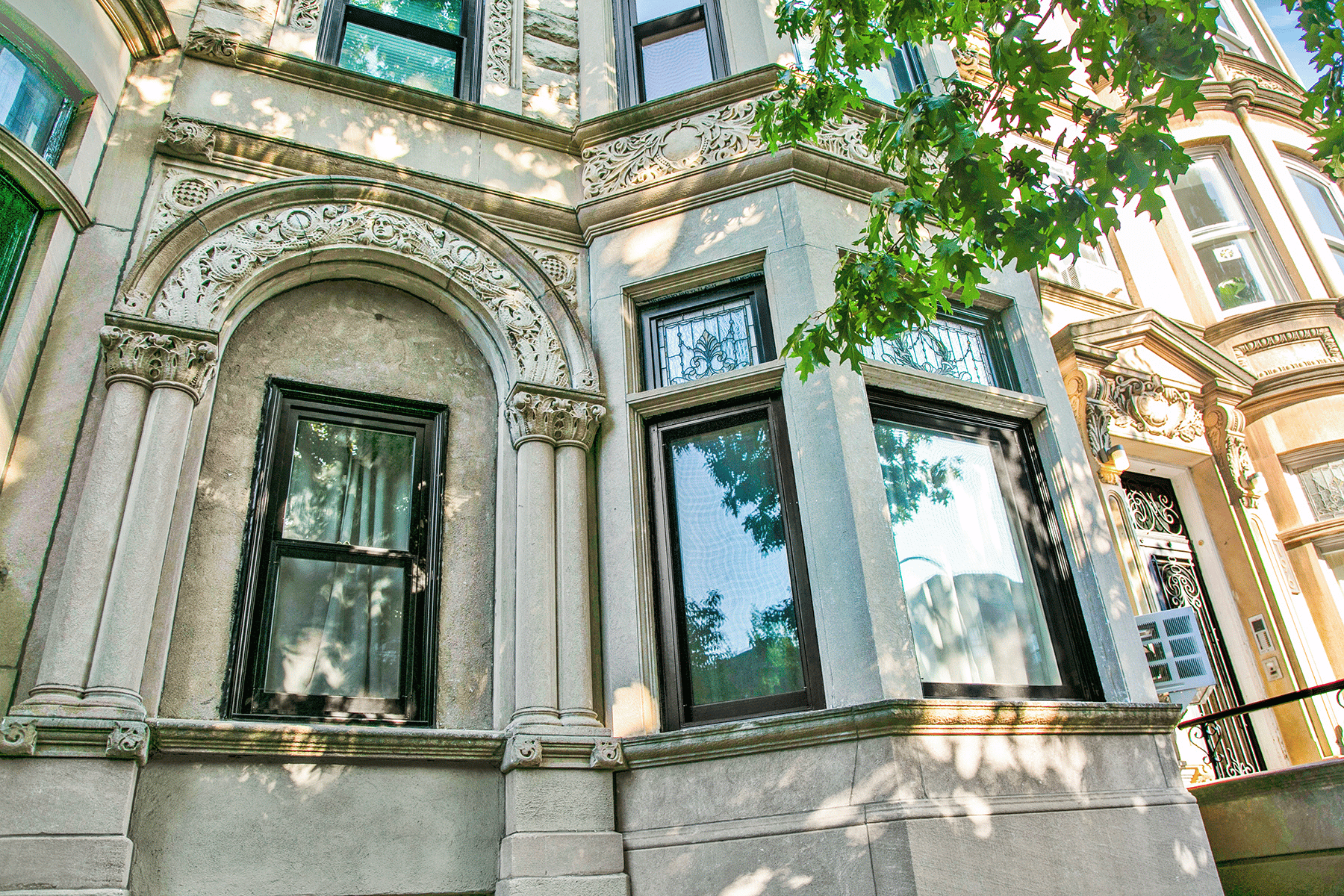 New windows in a marble stone style with bay windows and ornate trim