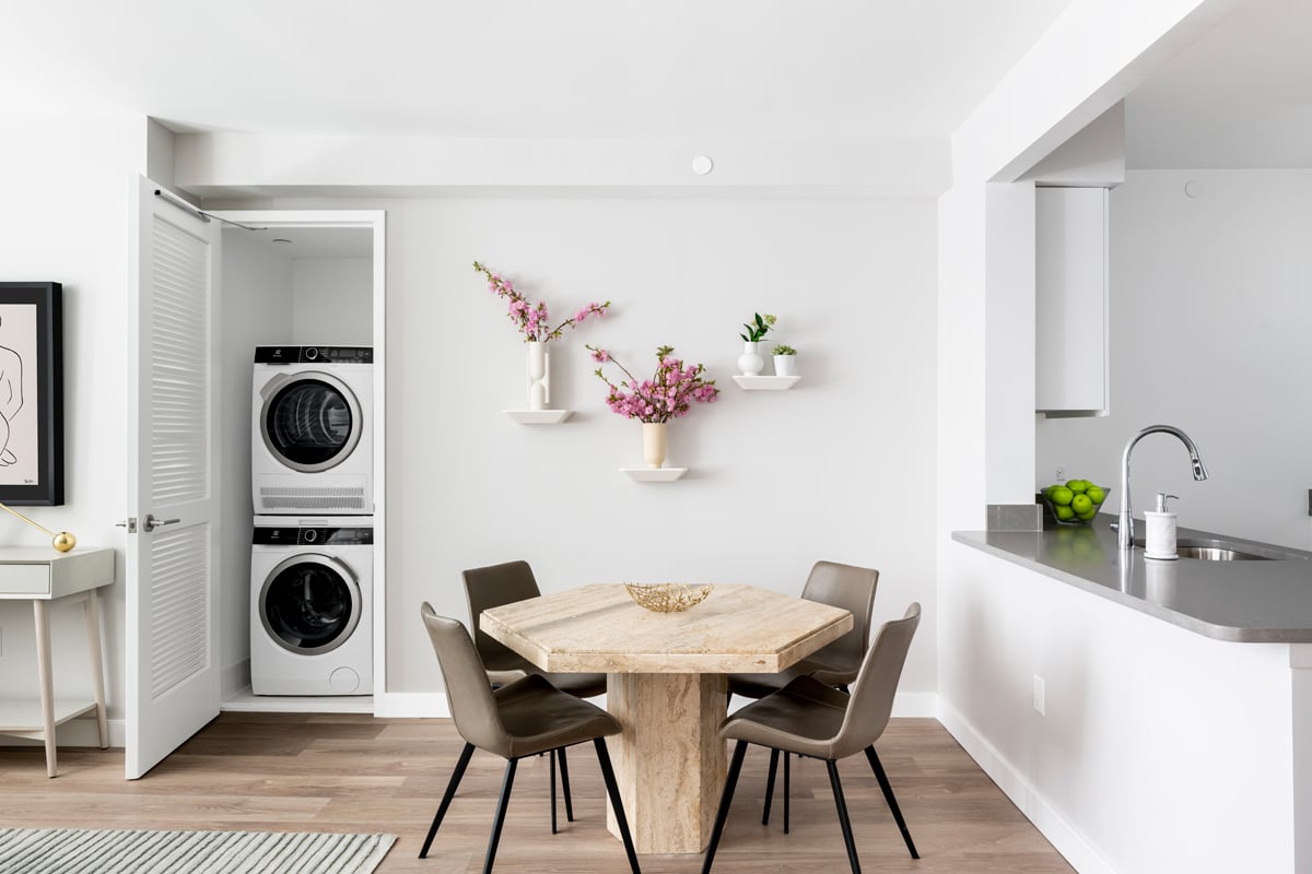 Dining room with laundry and opening to a pass-through kitchen