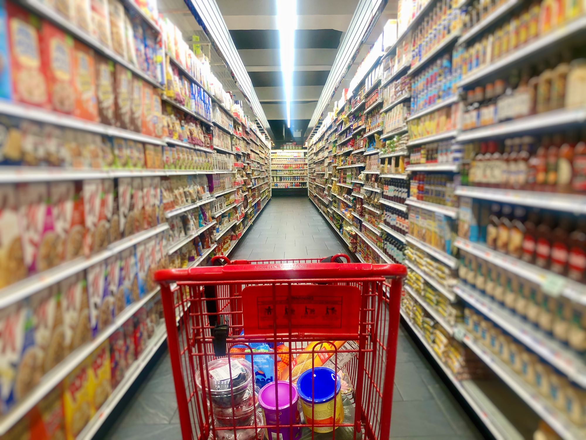 Shopping cart with food in the supermarket