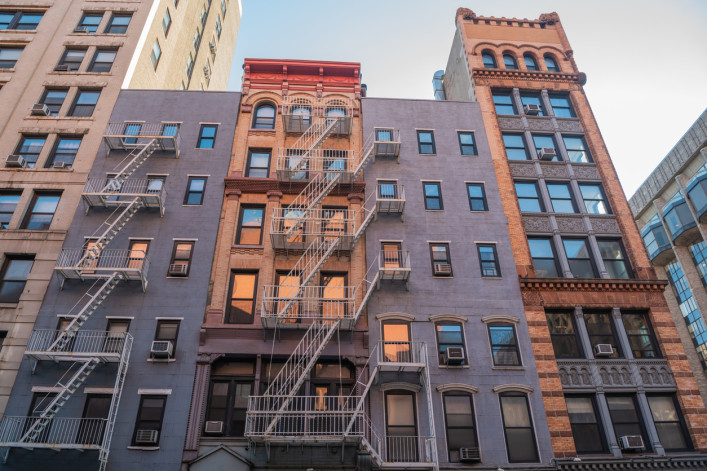 Historic buildings at the intersection of Mercer Street and West 4th Street in New York City.