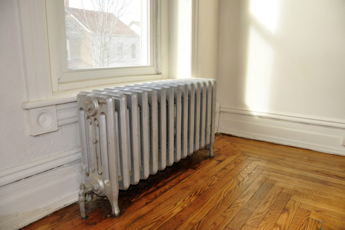 cast iron radiator next to a window