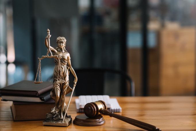 Statue of lady justice on desk of a judge or lawyer. stock photo
