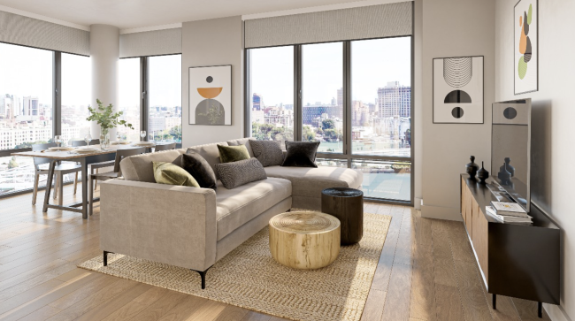 Screenshot 2023-02-24 at 10.13.30 AM.png living room with brown sofa, natural colors, wood floors, & large windows overlooking water