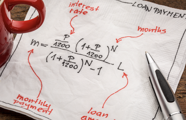 Screenshot 2023-03-10 at 2.55.04 PM.png loan payment equation sketched on a white napkin with a cup of coffee