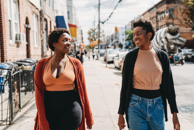 Two friends are walking in a street of Bushwick, Brooklyn