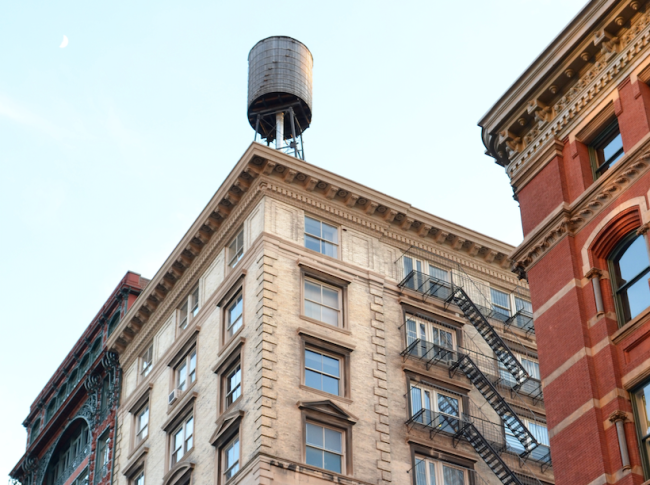 UES old building with water tower blue sky