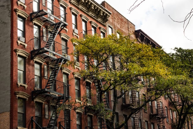 Close-up view of New York City style apartment buildings with emergency stairs along Mott Street in Chinatown neighborhood of Manhattan, New York, United States.