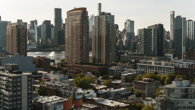 Condo buildings Hunters Point, Long Island City, Queens, with a view of Midtown Manhattan over the East River