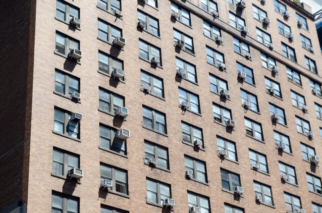 NYC apartment building with AC units