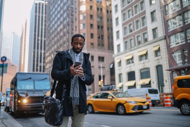 Man looking at his phone in NYC street