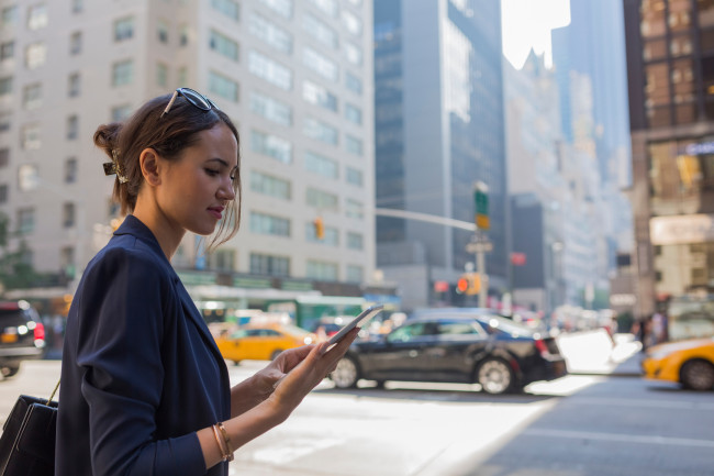 woman looking at her phone on a NYC street