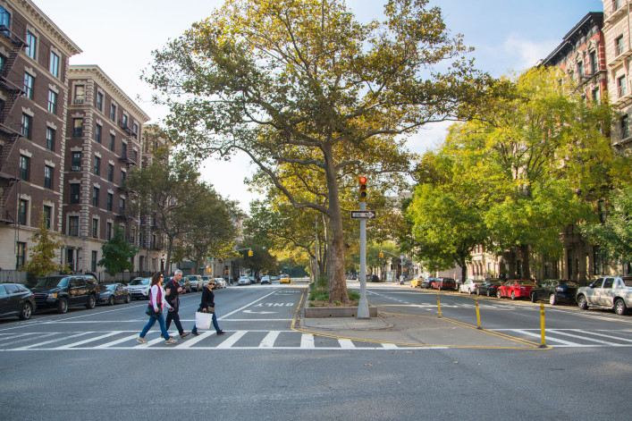 Shoppers walking in crosswalk Harlem, NYC