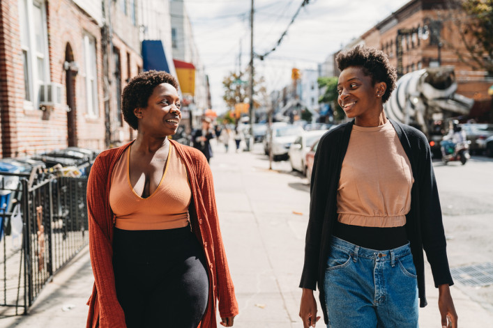 Two friends are walking in a street of Bushwick, Brooklyn