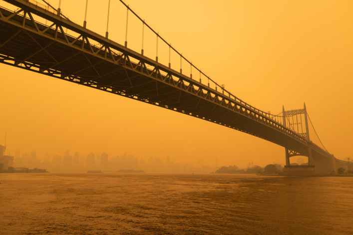 Smoke from wildfires obscures the Triborough Bridge.