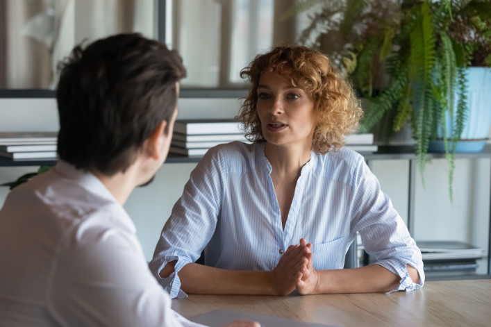 two people negotiating a deal at a table.