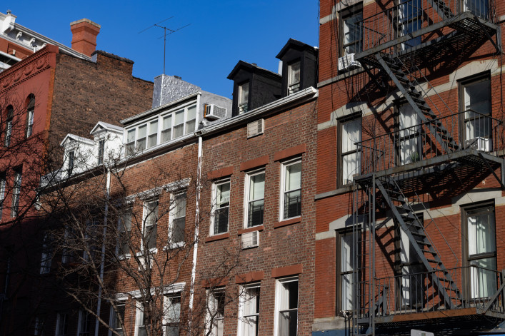 Row of Old Brick Residential Buildings with Fire Escapes in Greenwich Village 