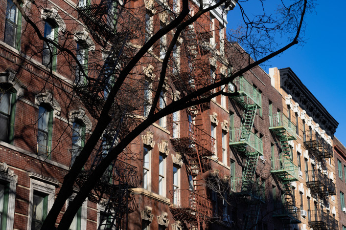 Row of Colorful Old Brick Residential Buildings with Fire Escapes in Greenwich Village of New York City stock photo