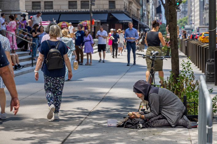 Pedestrians and homeless man on 5th Avenue in Manhattan Pedestrians and homeless man on 5th Avenue in Manhattan