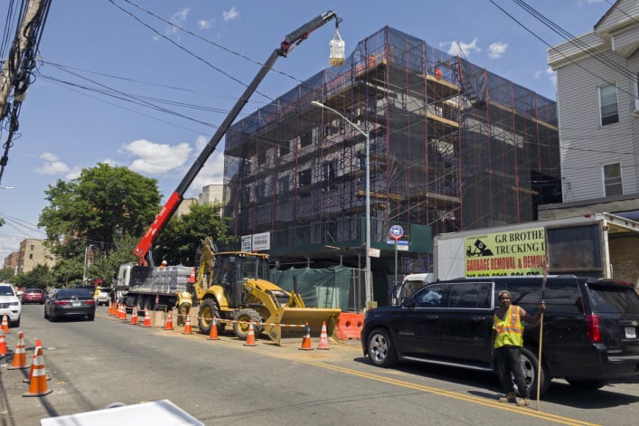 Construction work with a crane on new building in the Bronx NY