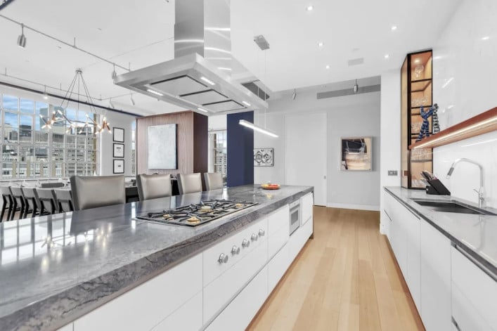 A brightly lit open kitchen with modern clean style and appliances