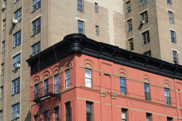 An image of the top of a brick New York City apartment building, including its parapet.