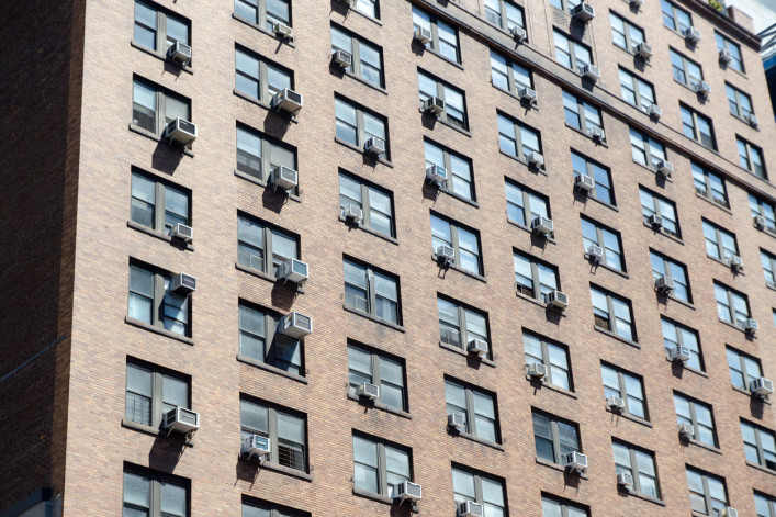 NYC apartment building with AC units
