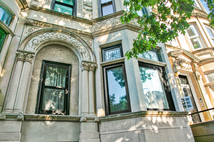 New windows in a marble stone style with bay windows and ornate trim