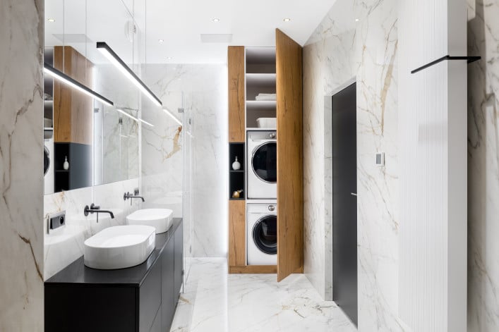stacked washer/dryer condo in a bathroom