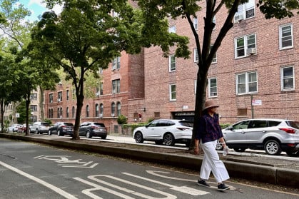Woman walking down street in Jackson Heights