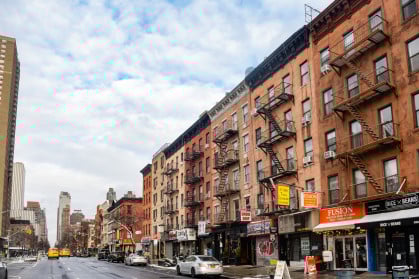 Manhattan street view of apartment buildings with street-level retail