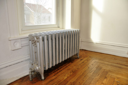cast iron radiator next to a window