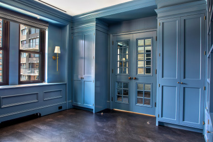 Blue cabinetry and window-paned interior doors
