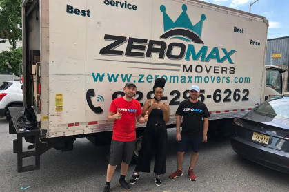 Zero Max Movers standing in front of one of their moving trucks