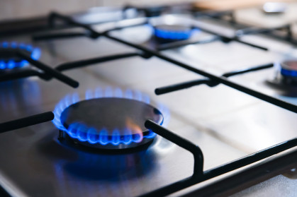 Gas kitchen stove cook with blue flames burning