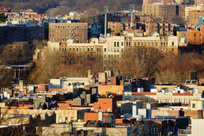 Buildings peek out above trees in Inwood, Manhattan.