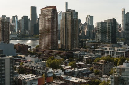 Condo buildings Hunters Point, Long Island City, Queens, with a view of Midtown Manhattan over the East River