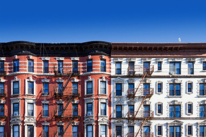New York City old historic apartment building in the East Village of Manhattan, NYC with a clear blue sky background
